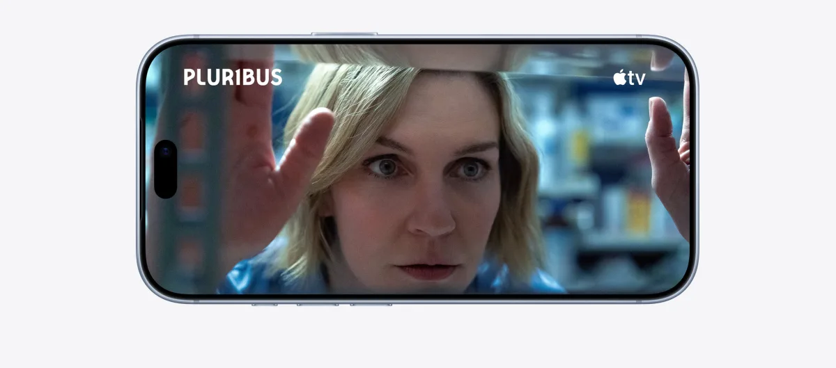iPhone 18 Pro, Burgundy color, front exterior in a horizontal position, Apple TV show "Silo" plays on screen, volume up/down buttons, action button